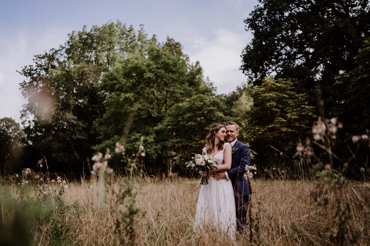 Hochzeitsfoto Braut vor Bräutigam Umarmung - Scheunenhochzeit in Brandenburg im Gutshaus Penzlin Hochzeitsfotograf Berlin © www.hochzeitslicht.de