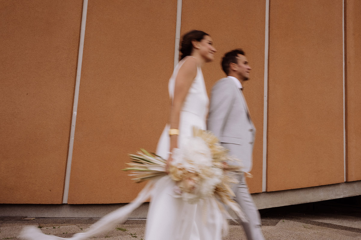 Hochzeitspaar mit Bewegungsunschärfe Langzeitbelichtung vor schöner Hochzeitslocation in Berlin aus der urbanen Elopement Hochzeitsreportage von Hochzeitsfotograf Berlin © www.hochzeitslicht.de #hochzeitslicht