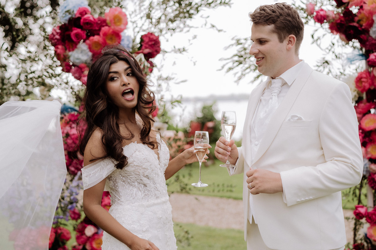 witziger Hochzeitsmoment Braut verliert Schleier - Hochzeitsfotografin aus Berlin auf eleganter Gartenhochzeit in Hochzeitslocation Potsdam am Wasser im Gut Schloss Golm während Corona Pandemie © www.hochzeitslicht.de #hochzeitslicht