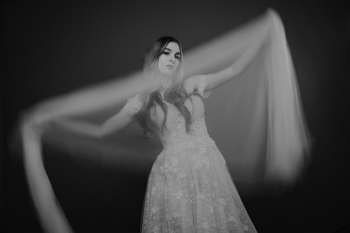 bride waves her veil during a wedding photo shoot in the studio in Berlin