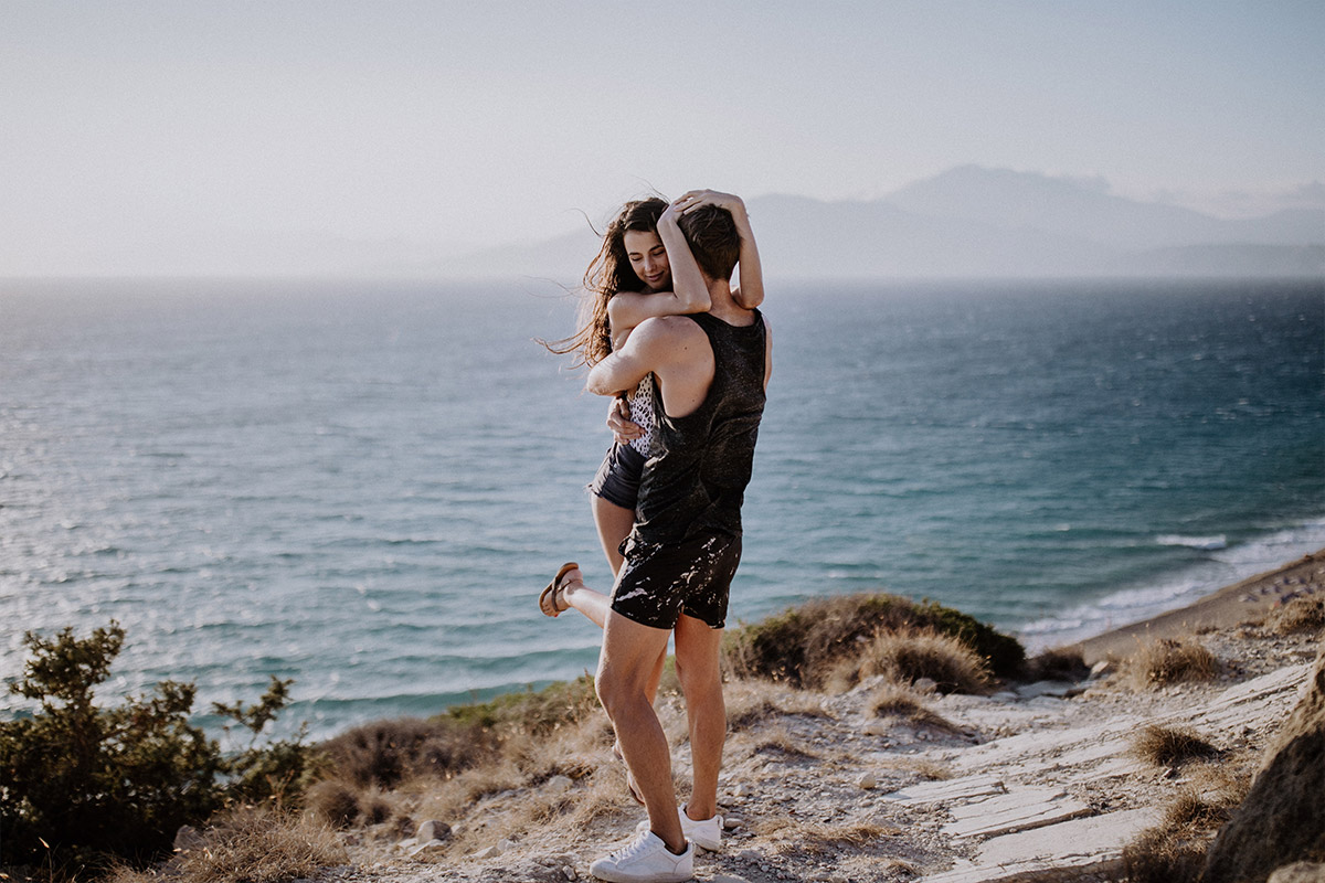 natural beach engagement photo ideas: he carries her in his arms