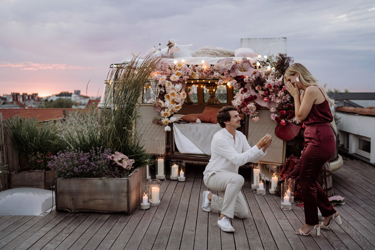 engagement photographer Berlin shoots moment of marriage proposal on rooftop terrace with classic VW camper van